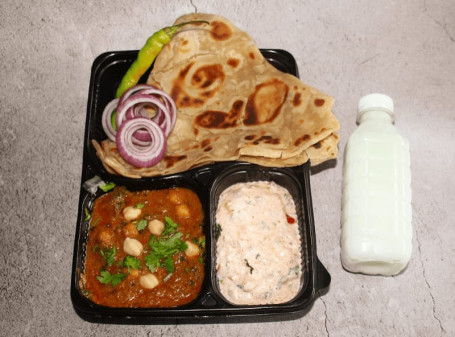 Chole (200Gms) Tawa Paratha 3Pc Veg Pulav (250Gms) Sweet 1Pc Raita (50Gms) Salad Pickel